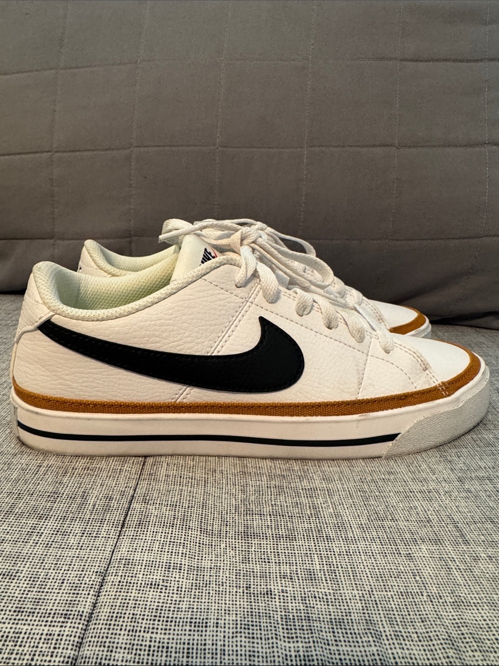 Nike White Low-Top Sneakers with Black Swoosh and Brown Accent